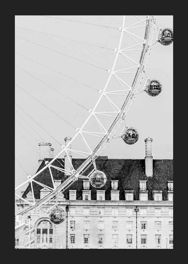 Black and white photo of London Eye against classic building-12