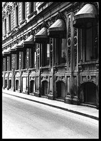 Black and white facade of old city street with decorated windows-6