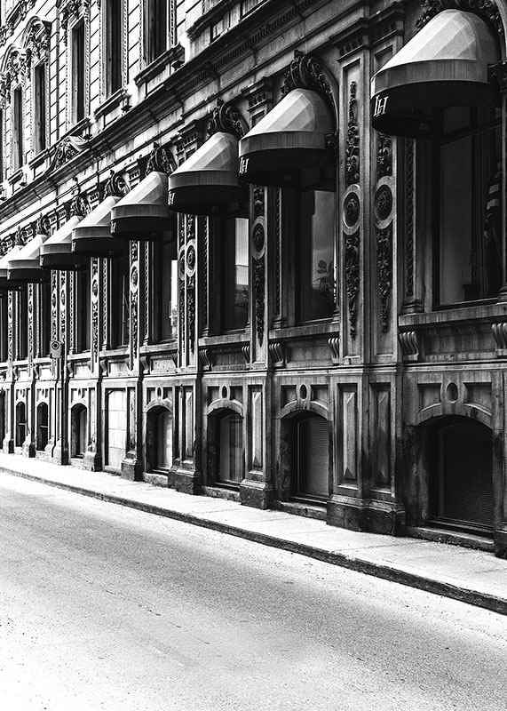 Black and white facade of old city street with decorated windows-12