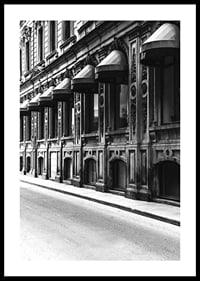 Black and white facade of old city street with decorated windows-0