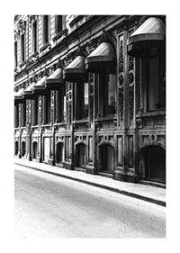 Black and white facade of old city street with decorated windows-1