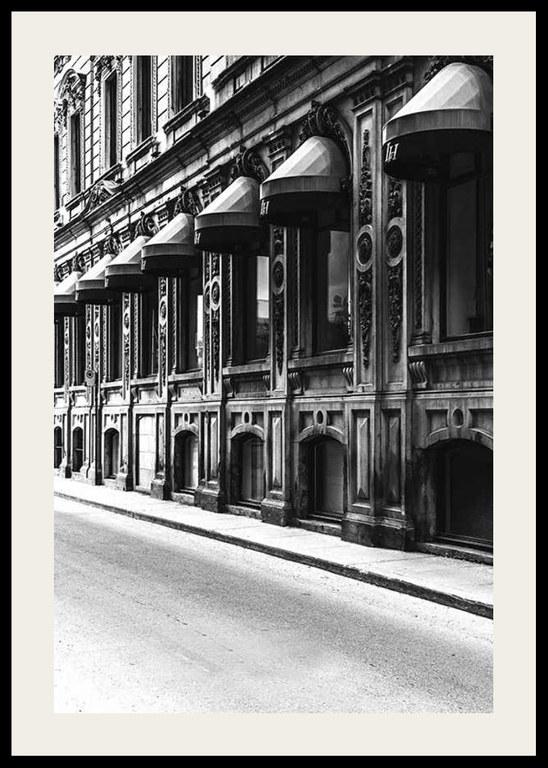 Black and white facade of old city street with decorated windows-12