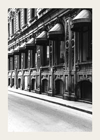 Black and white facade of old city street with decorated windows-3