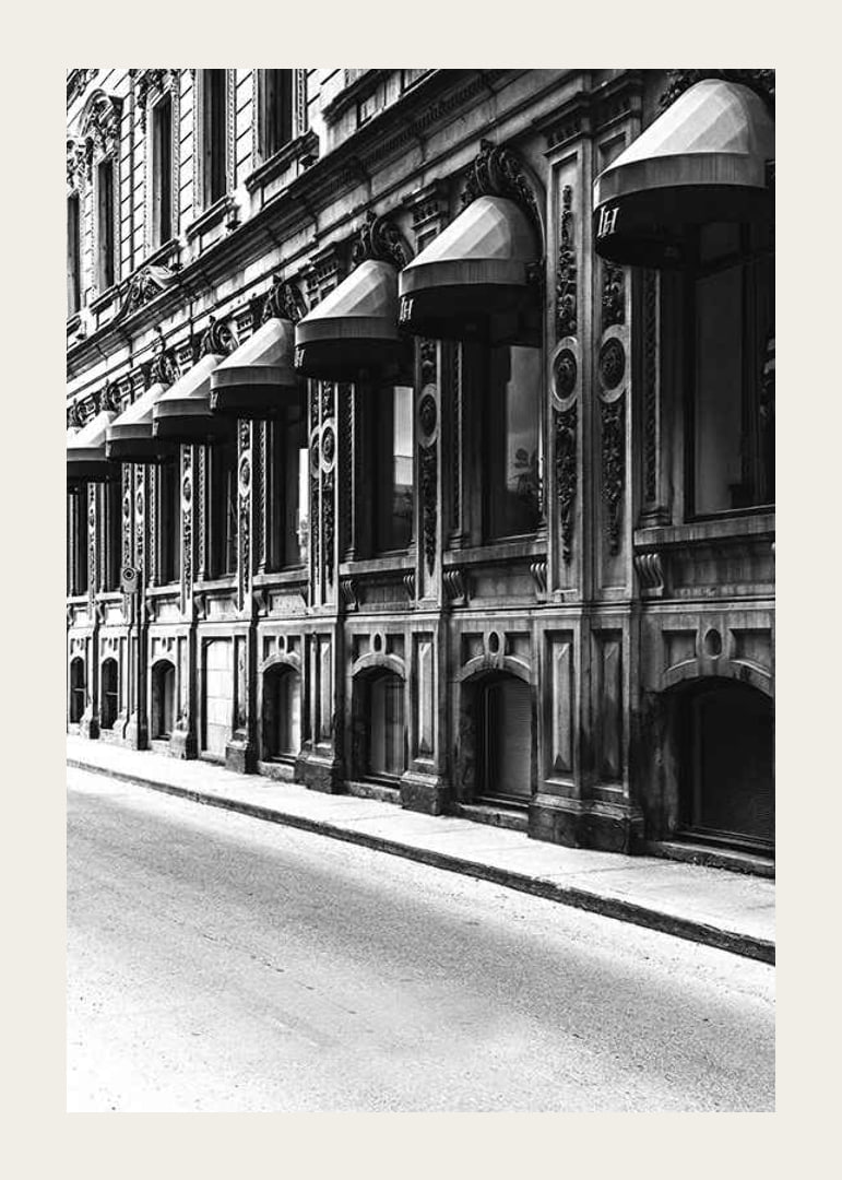 Black and white facade of old city street with decorated windows-12