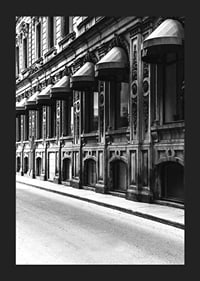 Black and white facade of old city street with decorated windows-5
