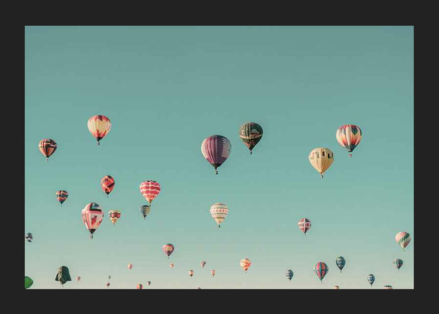 Colorful hot air balloons against clear turquoise sky, photography-12