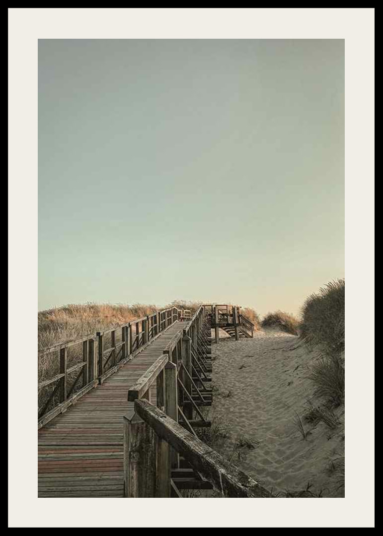 Photograph of wooden pier over sand dunes against bright sky-12