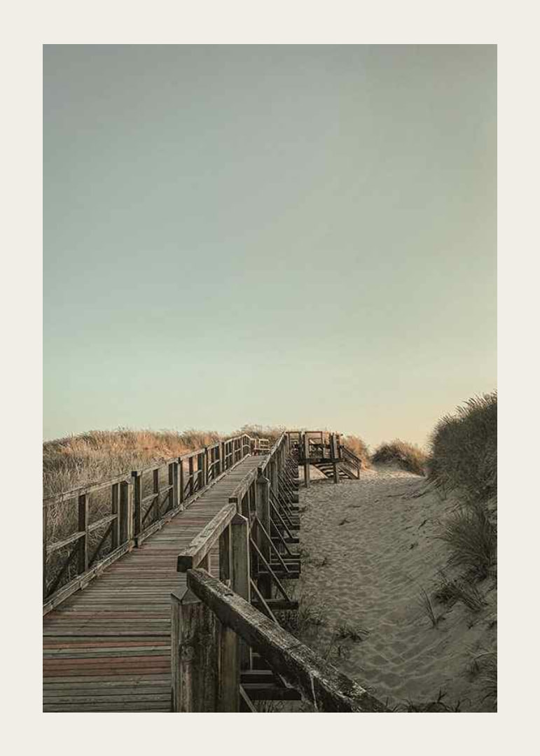 Photograph of wooden pier over sand dunes against bright sky-12
