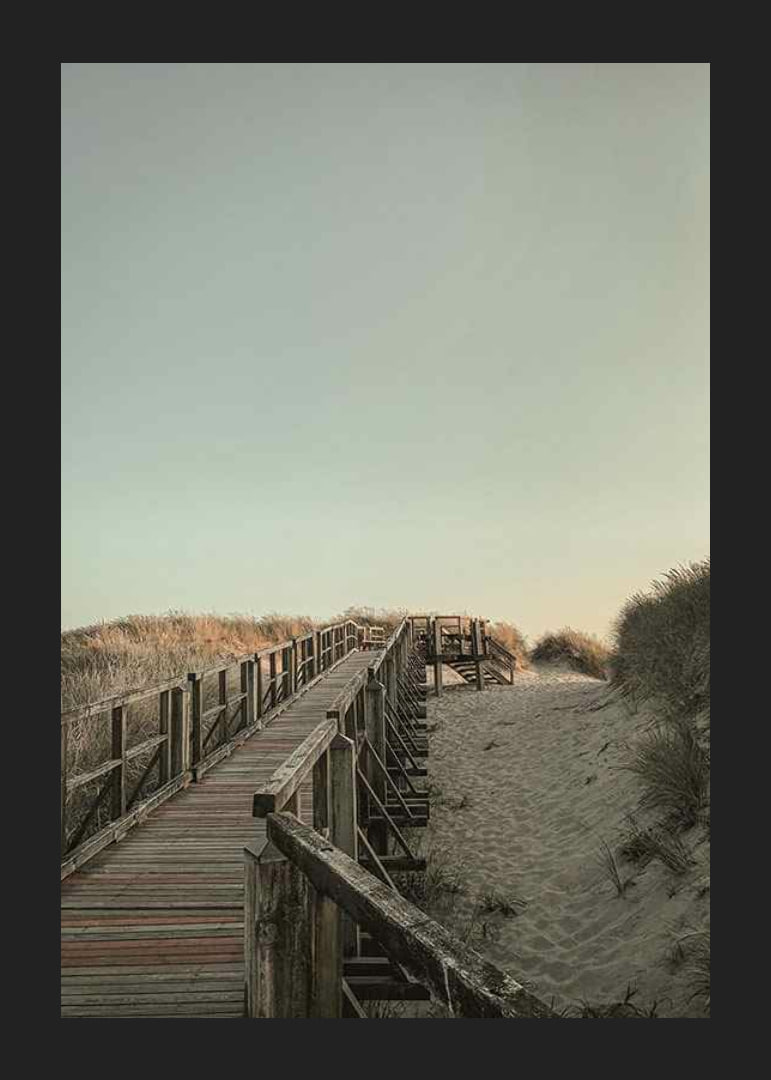 Photograph of wooden pier over sand dunes against bright sky-12