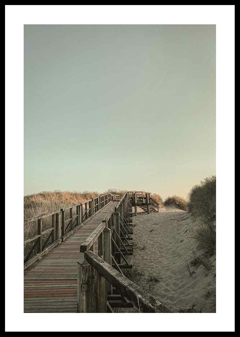 Photograph of wooden pier over sand dunes against bright sky-12