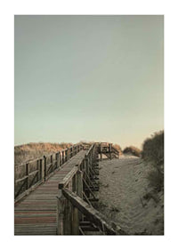 Photograph of wooden pier over sand dunes against bright sky-1