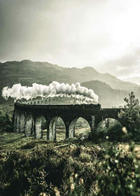 Photograph of train on Glenfinnan Viaduct in green valley-7