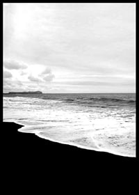Black and white photograph of waves against dark beach and horizon-6