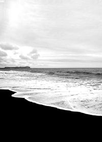 Black and white photograph of waves against dark beach and horizon-7