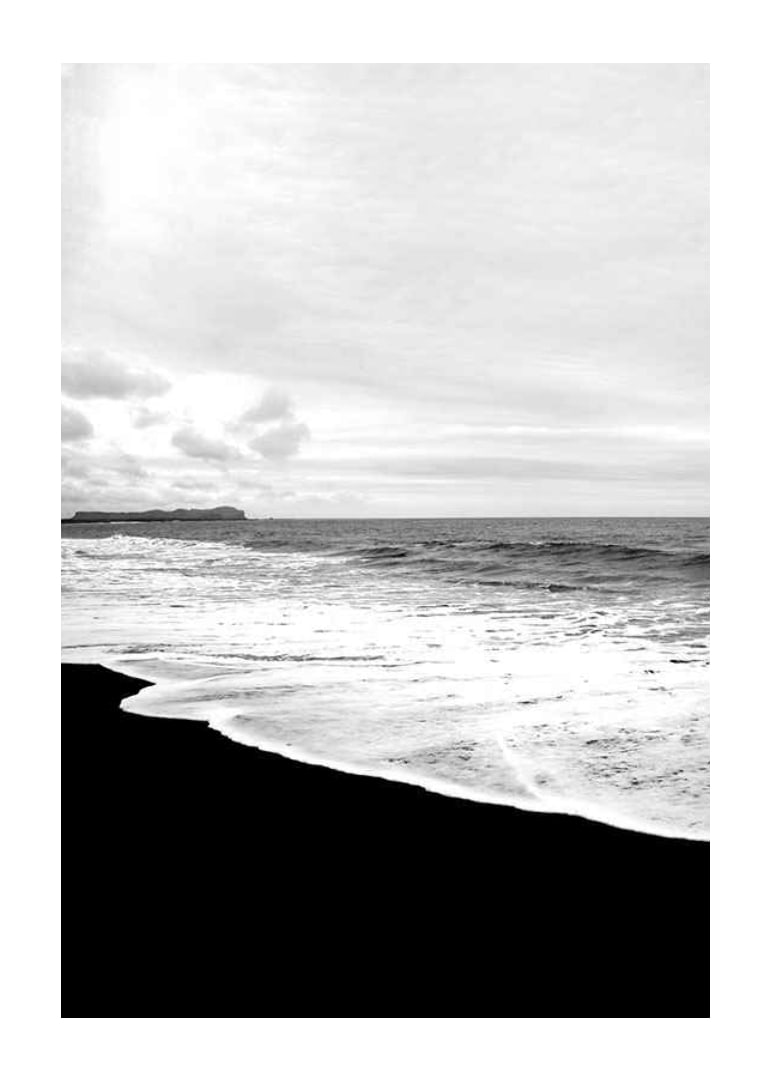 Black and white photograph of waves against dark beach and horizon-12