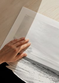 Black and white photograph of waves against dark beach and horizon-9