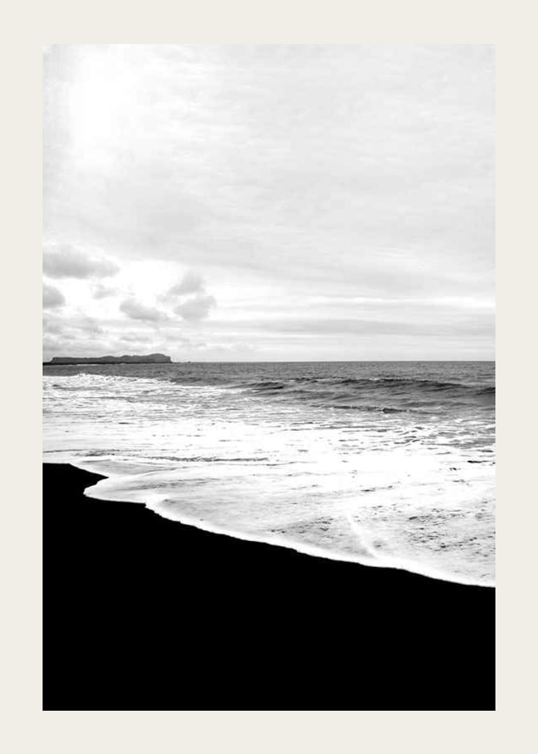 Black and white photograph of waves against dark beach and horizon-12