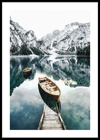 Photograph of rowboats on clear lake with snow-capped mountains-0