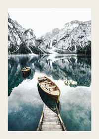 Photograph of rowboats on clear lake with snow-capped mountains-3