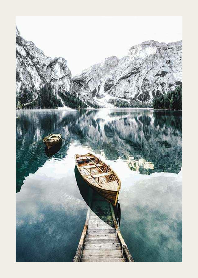 Photograph of rowboats on clear lake with snow-capped mountains-12
