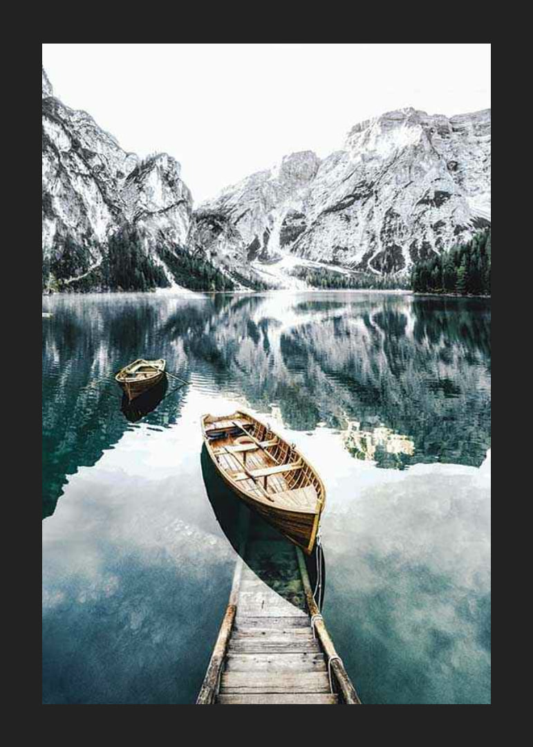 Photograph of rowboats on clear lake with snow-capped mountains-12