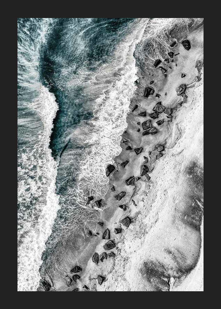 Bird's eye view of rocky beach with turquoise sea water-12