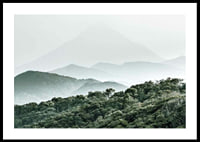 Mist-shrouded mountains and dense forest in soft green tones-0