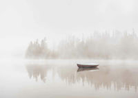 Red rowboat on calm lake with fog and forest in the background-7
