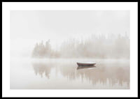 Red rowboat on calm lake with fog and forest in the background-0