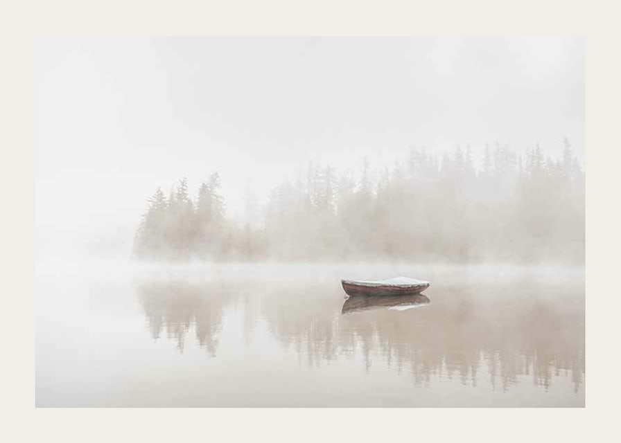 Red rowboat on calm lake with fog and forest in the background-12