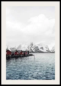 Photograph of red fishing huts by the water and snow-capped mountains-2
