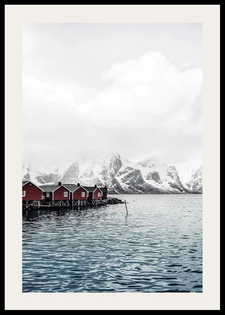 Photograph of red fishing huts by the water and snow-capped mountains-12