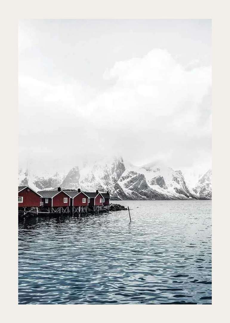 Photograph of red fishing huts by the water and snow-capped mountains-12