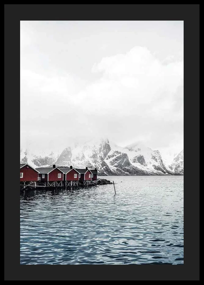 Photograph of red fishing huts by the water and snow-capped mountains-12
