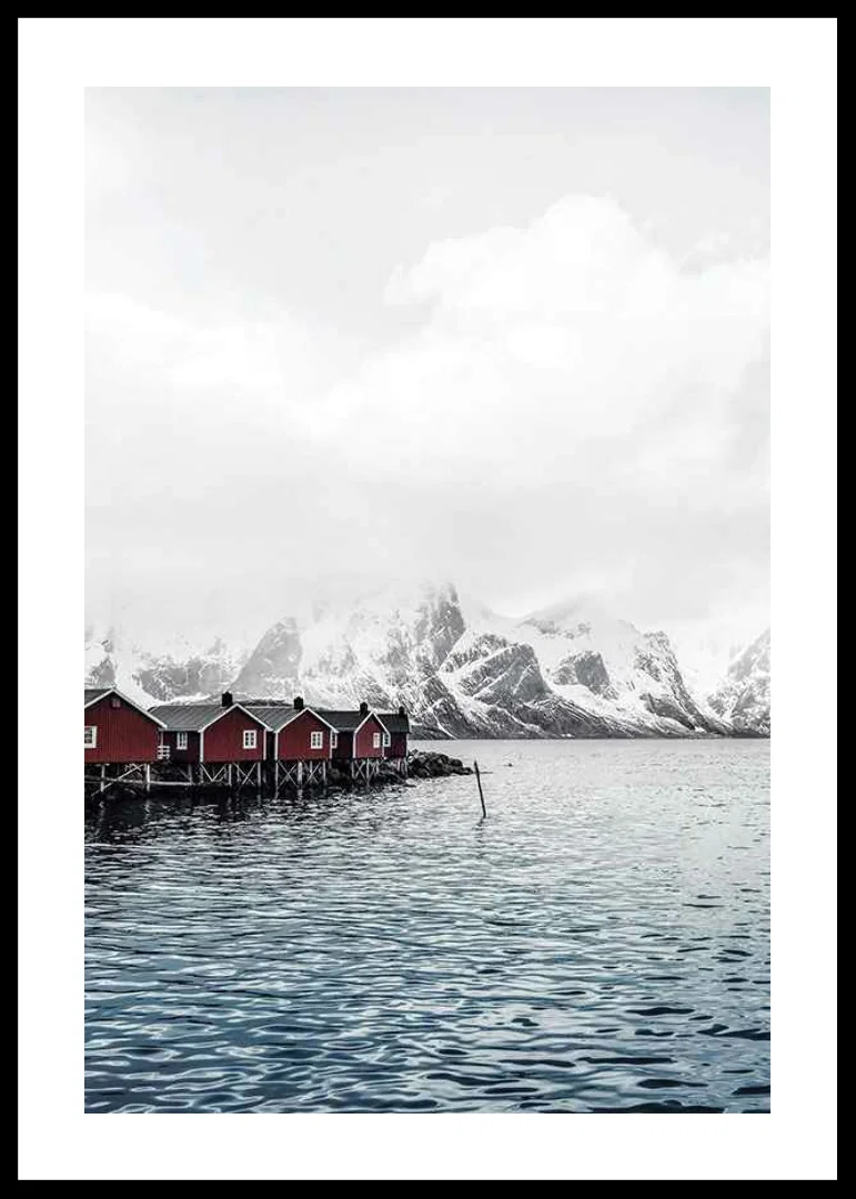 Photograph of red fishing huts by the water and snow-capped mountains-12