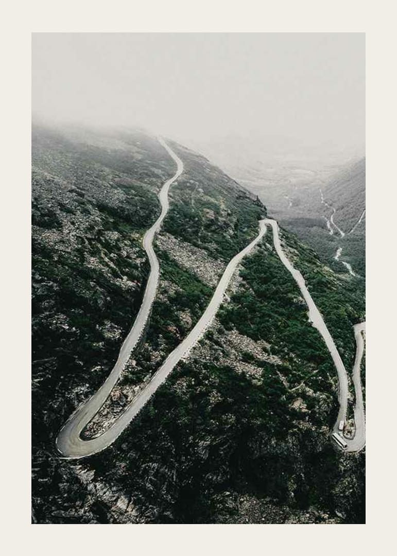 Ilmakuva mutkittelevasta Trollstigen-tiestä sumuisessa vuoristomaisemassa-12