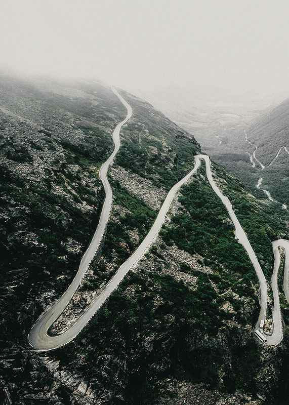Aerial view of the winding road Trollstigen in a foggy mountain landscape-12