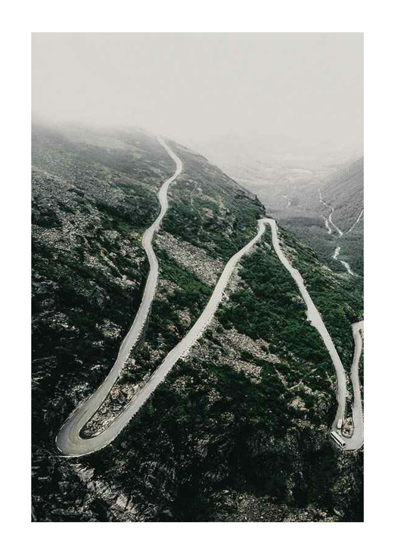 Aerial view of the winding road Trollstigen in a foggy mountain landscape-12