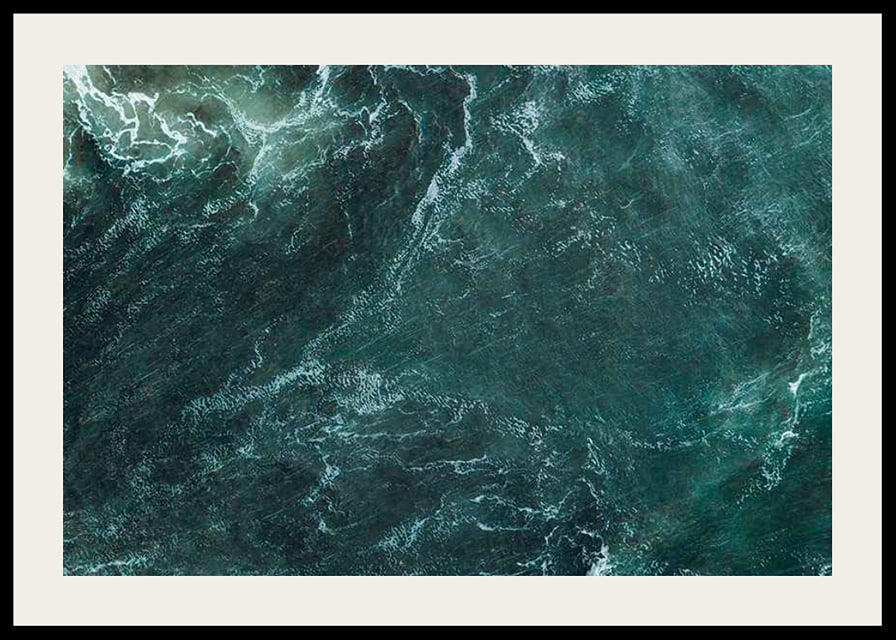Aerial view of turquoise sea with white wave patterns and foam-12