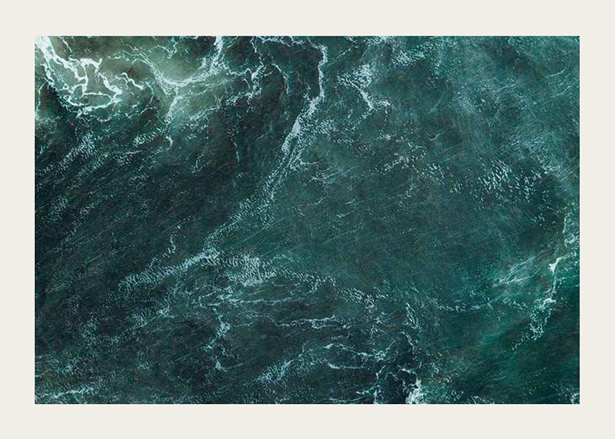 Aerial view of turquoise sea with white wave patterns and foam-12