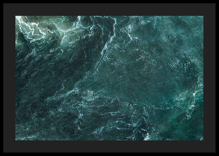Aerial view of turquoise sea with white wave patterns and foam-12