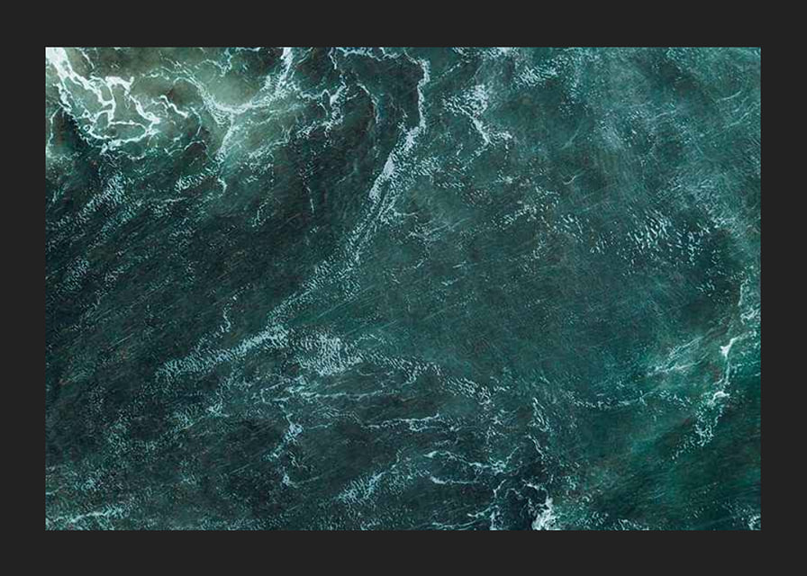 Aerial view of turquoise sea with white wave patterns and foam-12