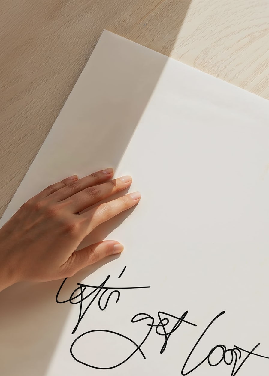 Black handwritten text 'let's get lost' on white background-12