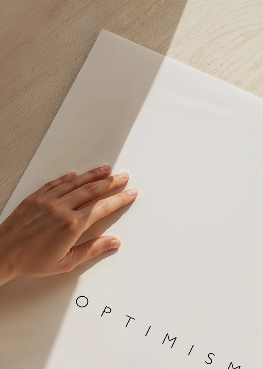Minimalistic text with the word optimism in black on white background-12