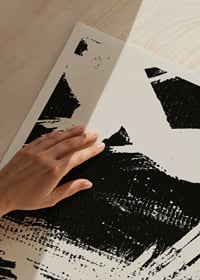 Abstract black brush strokes against sand-colored background-3