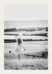 Black and white photograph of woman in dress in Danish countryside-3