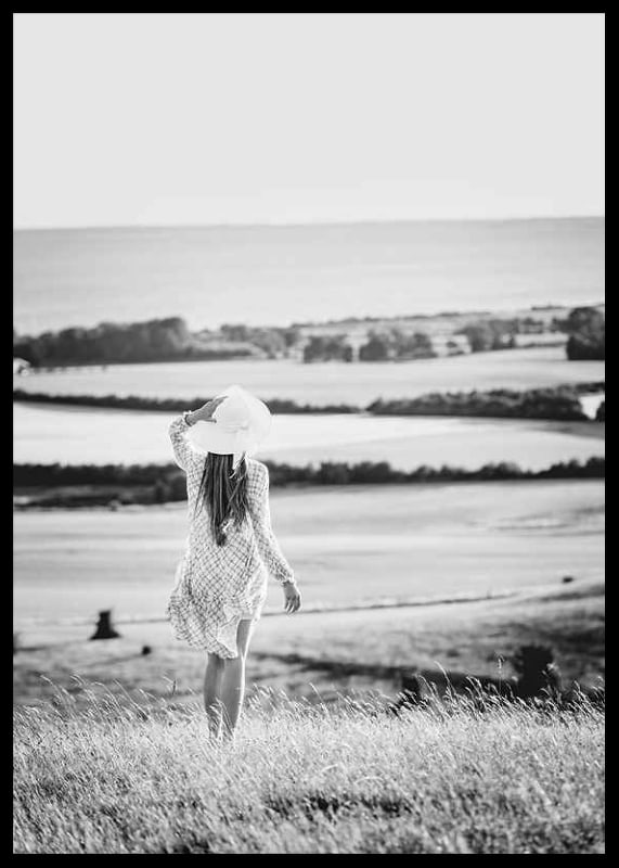 Black and white photograph of woman in dress in Danish countryside-12