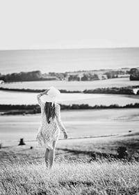 Black and white photograph of woman in dress in Danish countryside-7