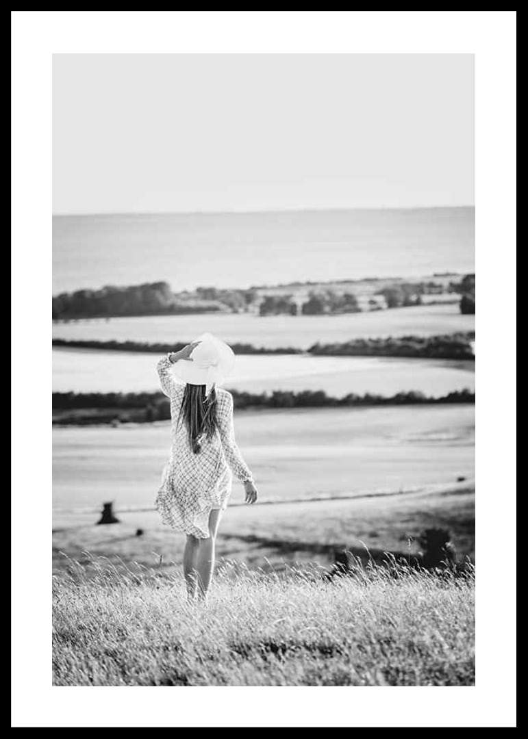 Black and white photograph of woman in dress in Danish countryside-12