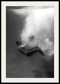 Black and white photograph of man sinking below water surface-2